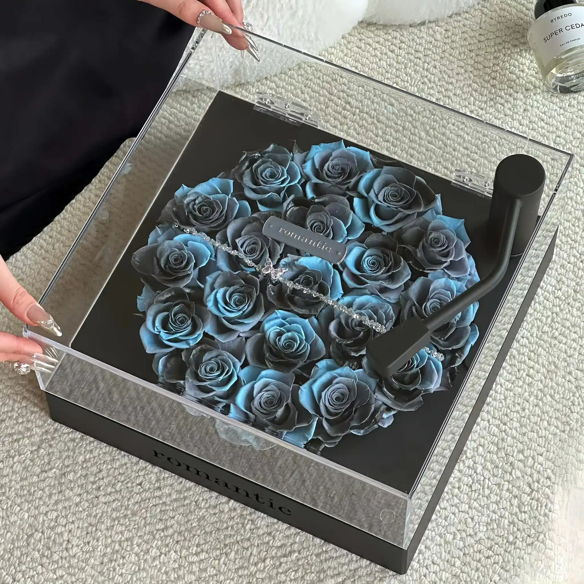 LULU ROSÉE Close-Up of Aqua Blue Rose Turntable, Light Blue Preserved Rose Arrangement