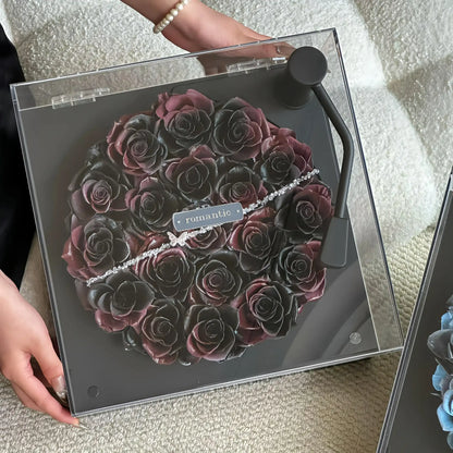 LULU ROSÉE Close-Up of Vintage Noir Rose Turntable, Dark Purple Preserved Rose Arrangement