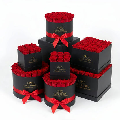 Stack of black boxes with red roses and ribbons, featuring Lulu Rosee branding.